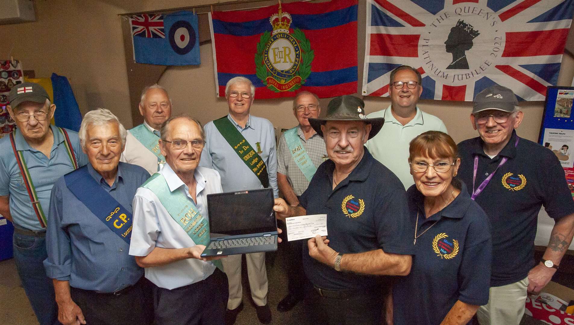 Cheque presentation with new laptop from The Locomotive Lodge March to March Armed Forces and Veterans Hub. Pictured handing cheque Rod MacGregor (Locomotive Lodge) to Jeff Walters (Veterans Hub) with supporters.