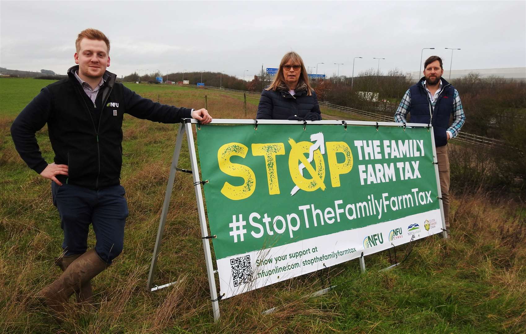 NFU Cambridgeshire Chair Alison Morris, centre, with a Stop the Family Farm Tax banner. She is pictured with NFU Cambridgeshire county adviser Rory Kerr, left, and NFU member and Cambridgeshire farmer Tom Martin, right. Picture: NFU