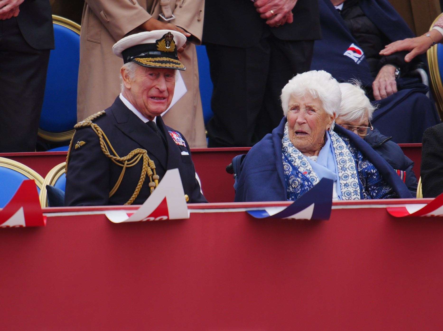 Charles speaks to Joy Trew during the military procession (Ben Birchall/PA)