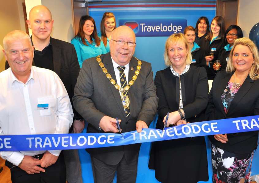 West Norfolk borough mayor David Whitby cuts the ribbon at King's Lynn's new Travelodge at its official opening. ANL-170113-153145001