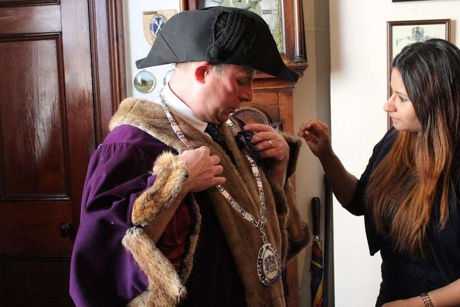 Andrew Lynn is helped into his official robes by wife Rima. (34868397)