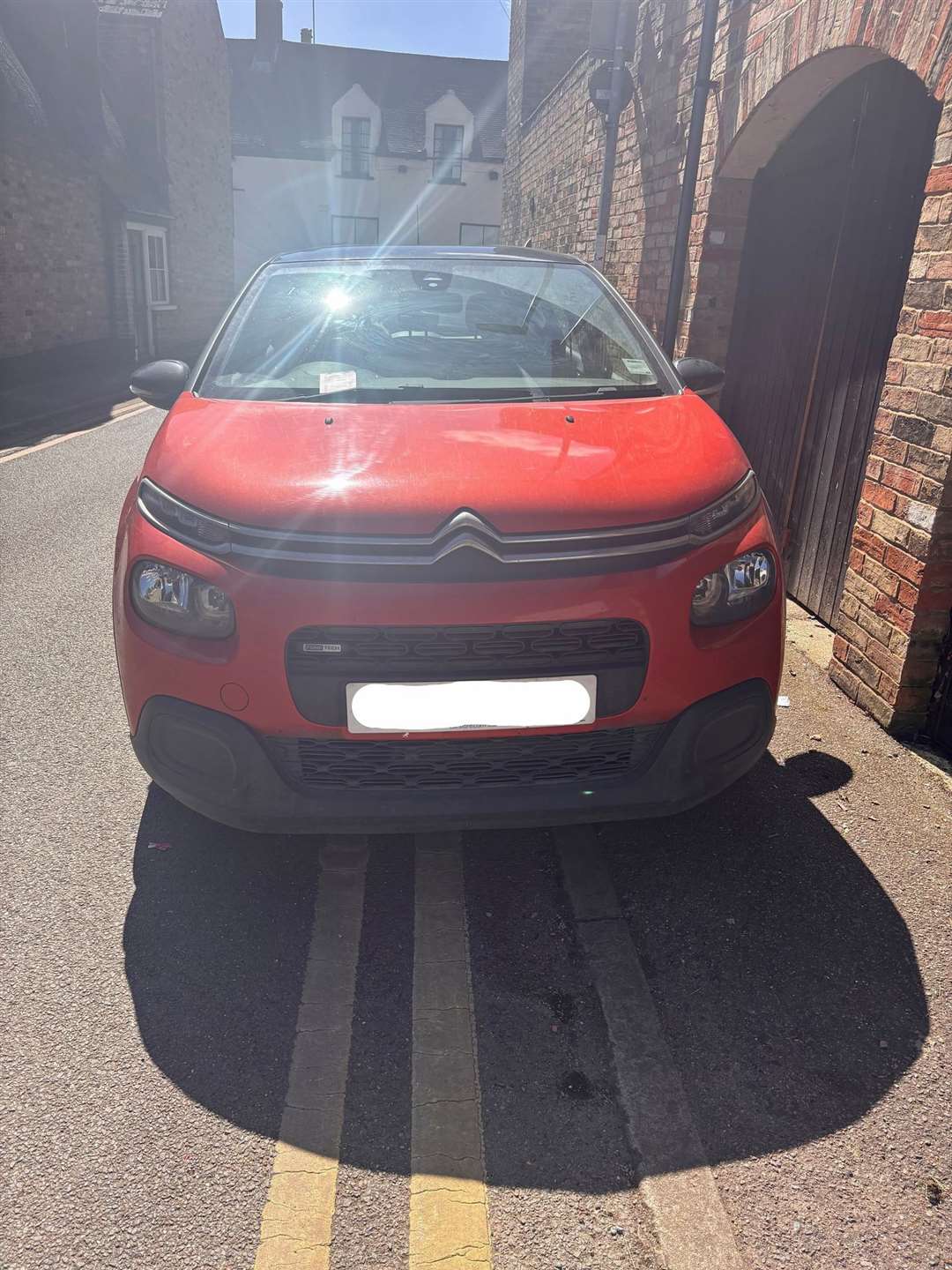 This car had a ticket slapped on it for parking on a double yellow line