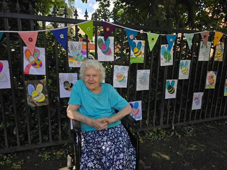 One of the residents with some of the bees that are decorating the home's railings.