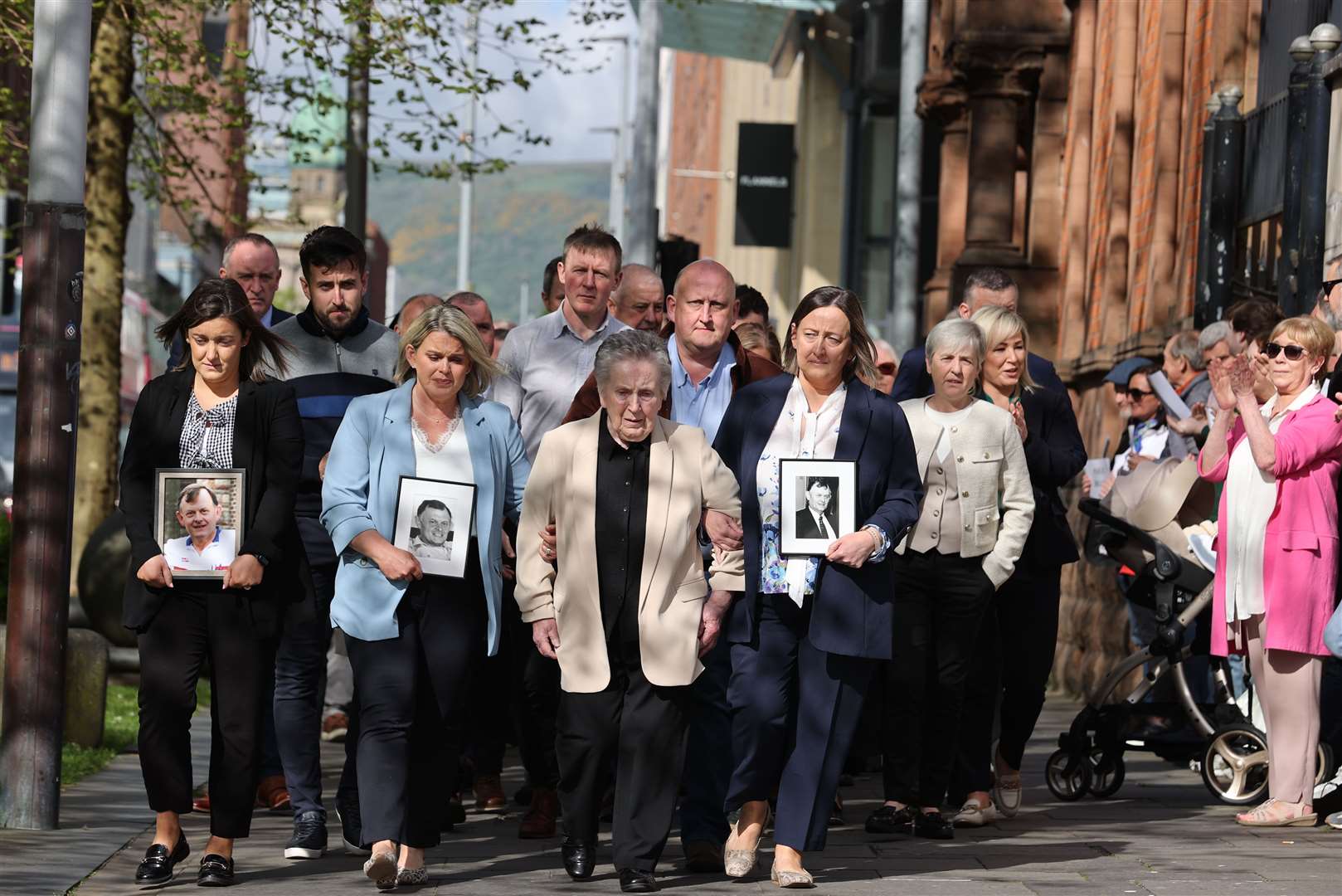 Supporters of the family of GAA official Sean Brown applaud as they arrive at court (Liam McBurney/PA)