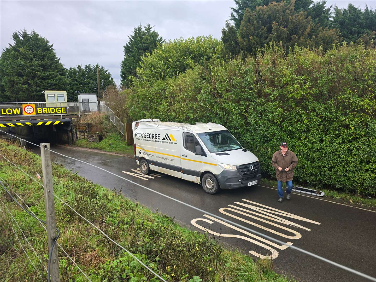 The driver of this Mick George van did manage to scrape his way under the bridge on Tuesday afternoon, but the vehicle paid the price. Picture: Sean Gray