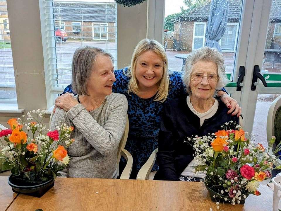 Making floral decorations on international flower day at Hickathrift care home