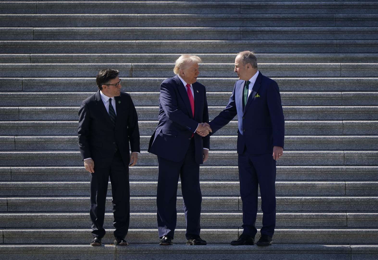 The Speaker of the United States House of Representatives Mike Johnson, US President Donald Trump and Taoiseach Micheal Martin on the steps of the US Capitol (Niall Carson/PA)