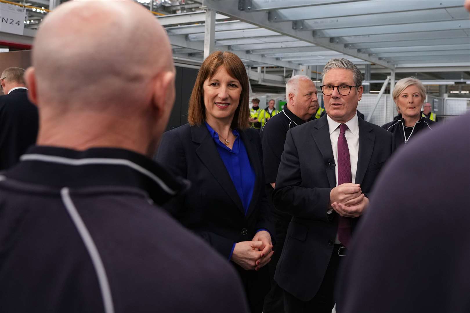 Prime Minister Sir Keir Starmer and Chancellor Rachel Reeves speaking to a staff member during a visit to Jaguar Land Rover in Birmingham (Kirsty Wigglesworth/PA)