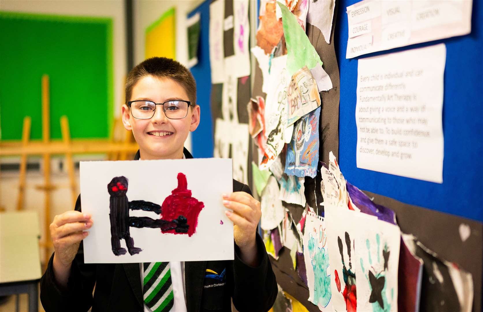 A student shows off his artwork. Photo: Ian Burt/Barking Dog Media.