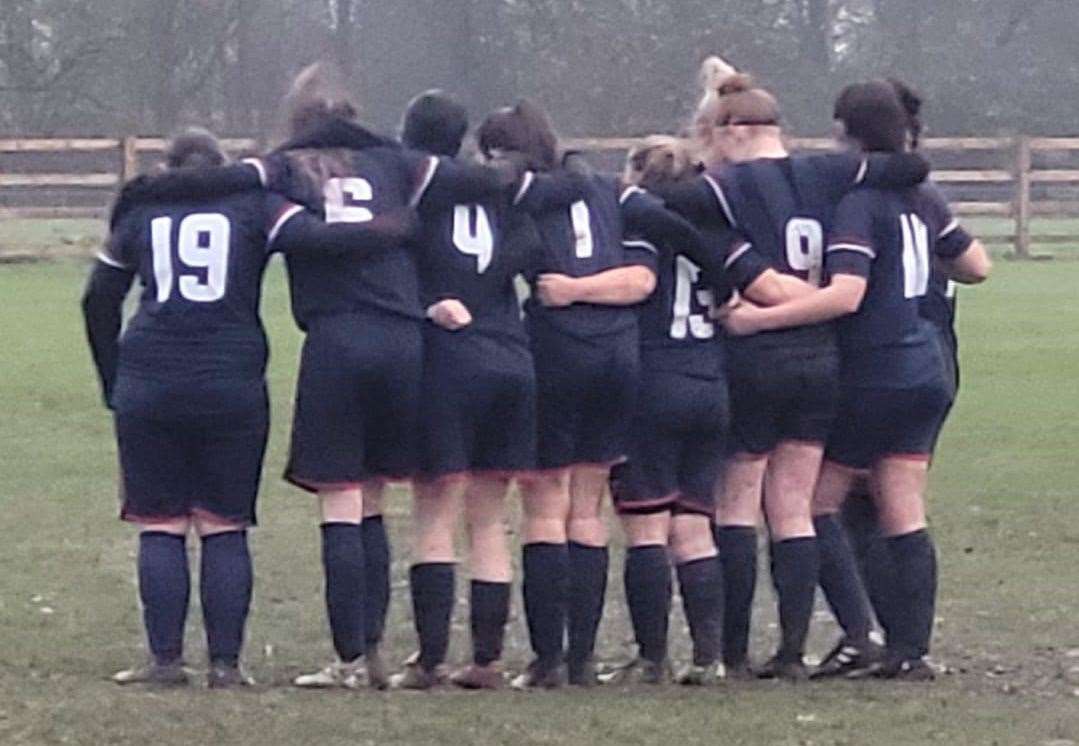 Park Ladies in a huddle before their game on Sunday