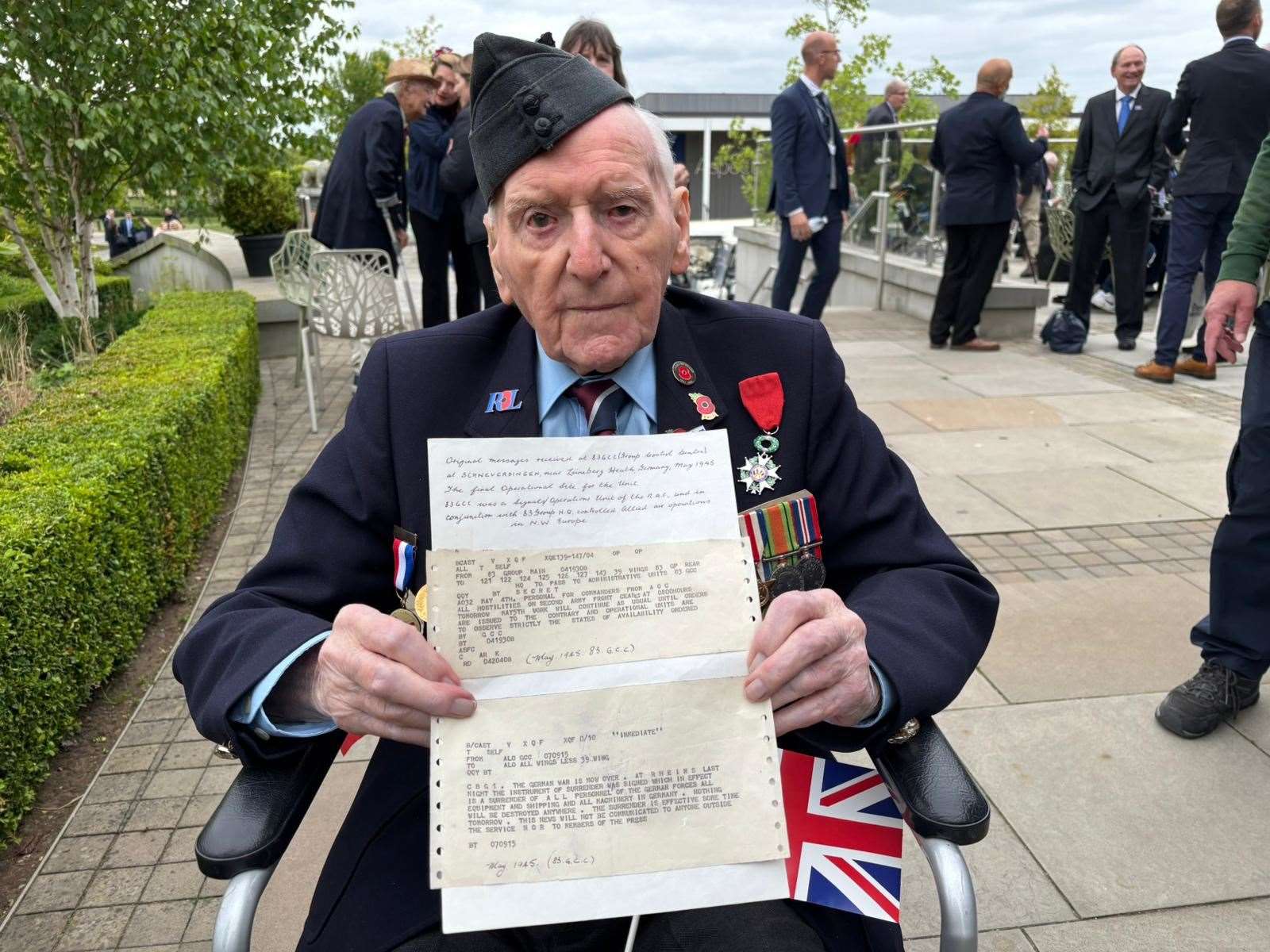 Bernard Morgan, 101, with the original telex he received two days before VE Day in 1945 explaining that the war was over (Stephanie Wareham/PA)