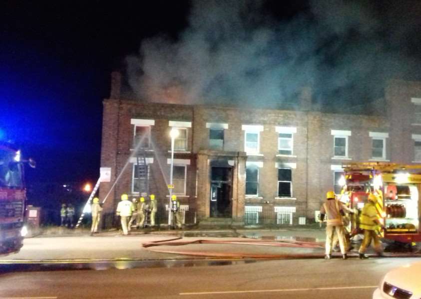 Michelle Pitt took this shot of firefighters aiming jets at one of the upper windows in The Bridge Hotel. ANL-160814-174721001