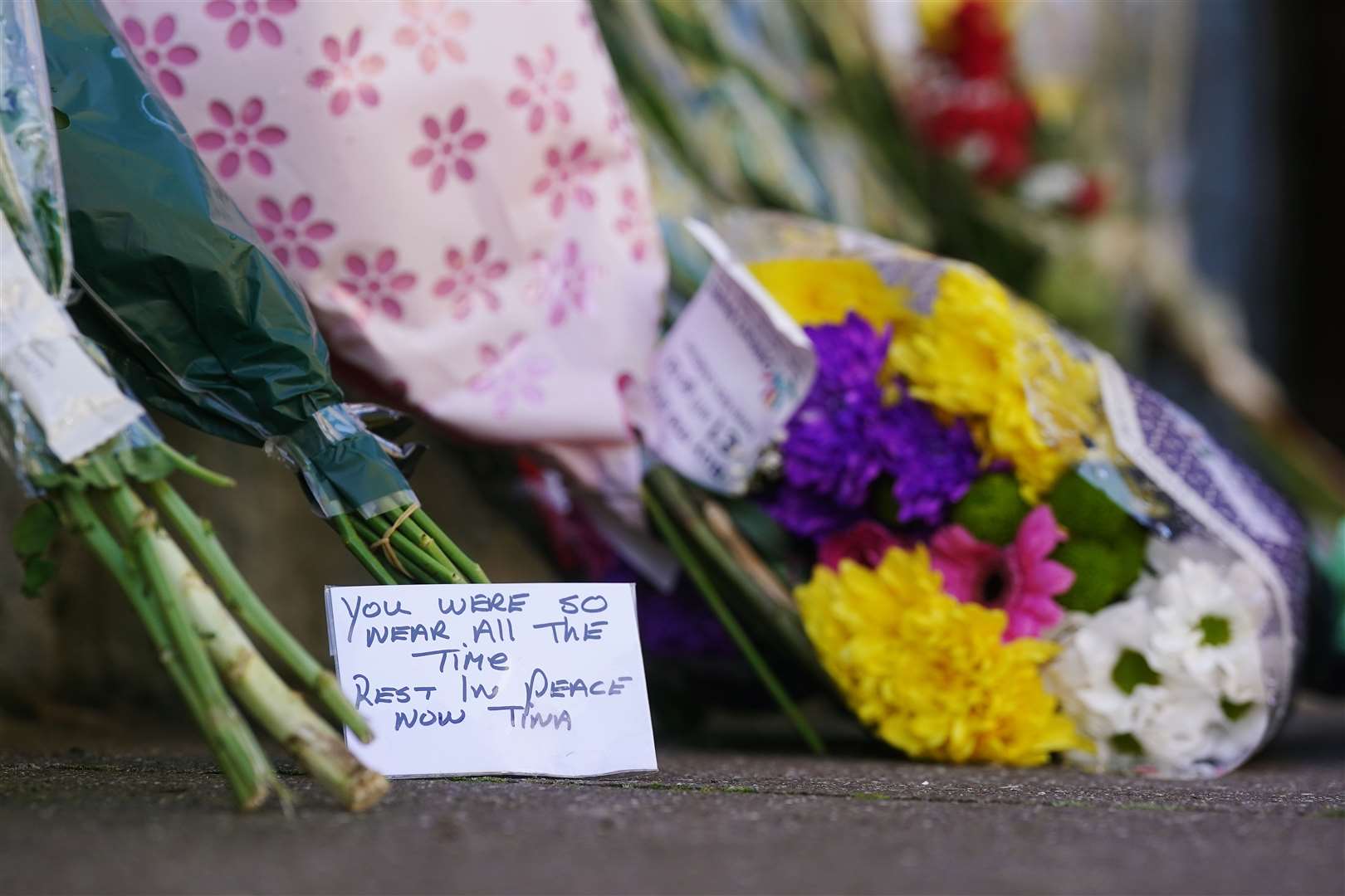 Flowers and messages left near to the scene in Youghal, Co Cork, where Tina Satchwell’s body was found (Brian Lawless/PA)