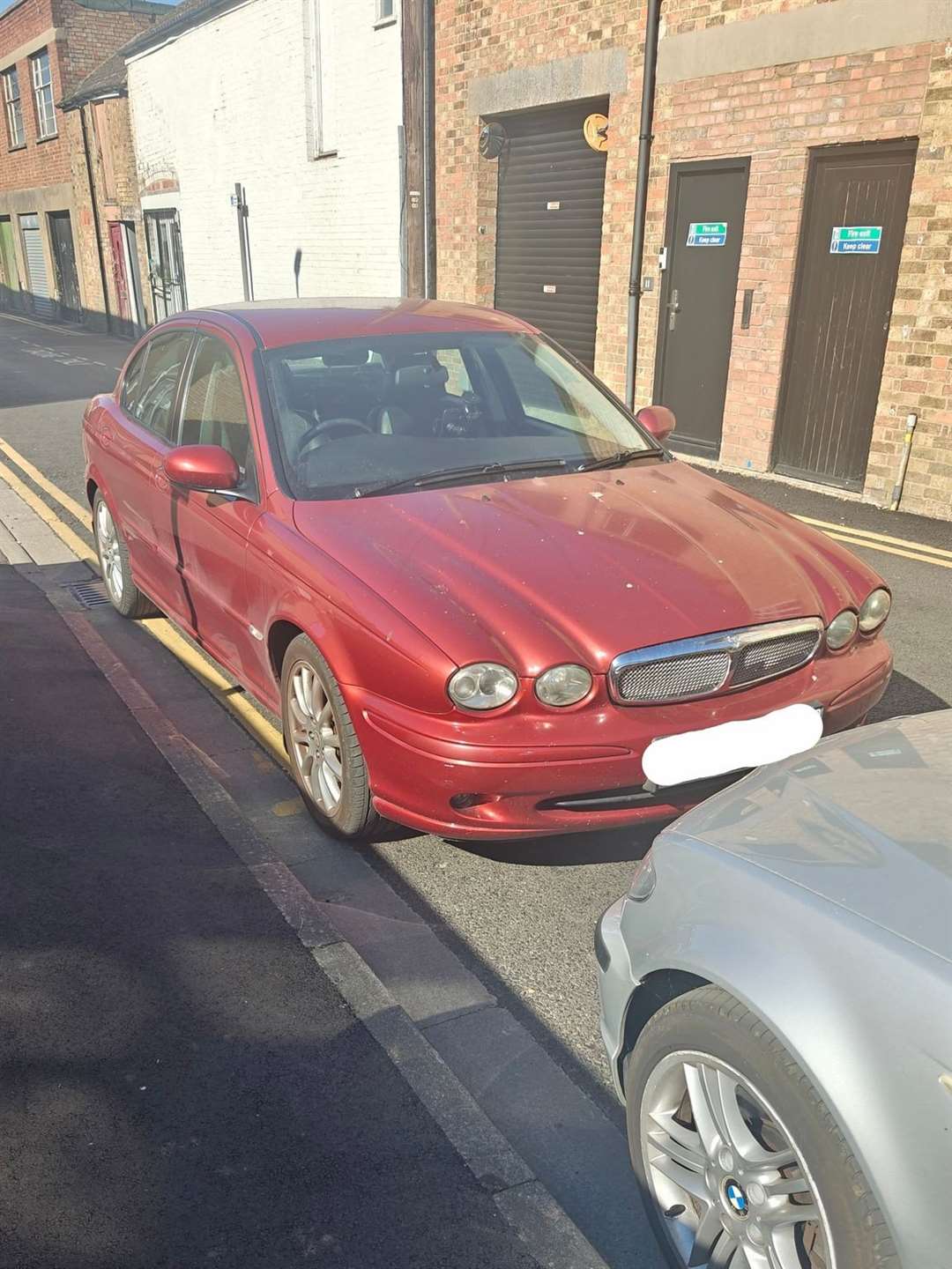 Another driver parked on a double yellow line
