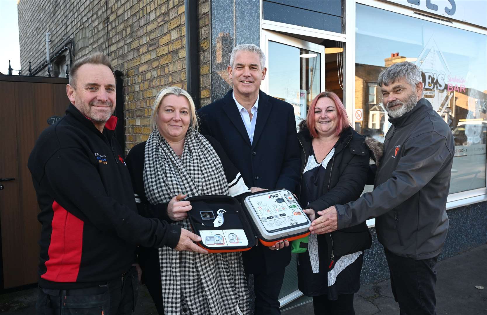 From left: Darren Biggs, Emma Cole, Steve Barclay, Jo Pope and Rob Skoulding with the 31st defibrillator to be installed in March