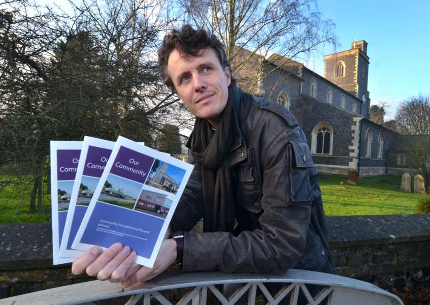 COMMUNITY GUIDE: Rev David Oxtoby outside St Matthew's Church with the new directory for Sutton Bridge, Our Community. Photo (TIM WILSON): SG200116-102TW.