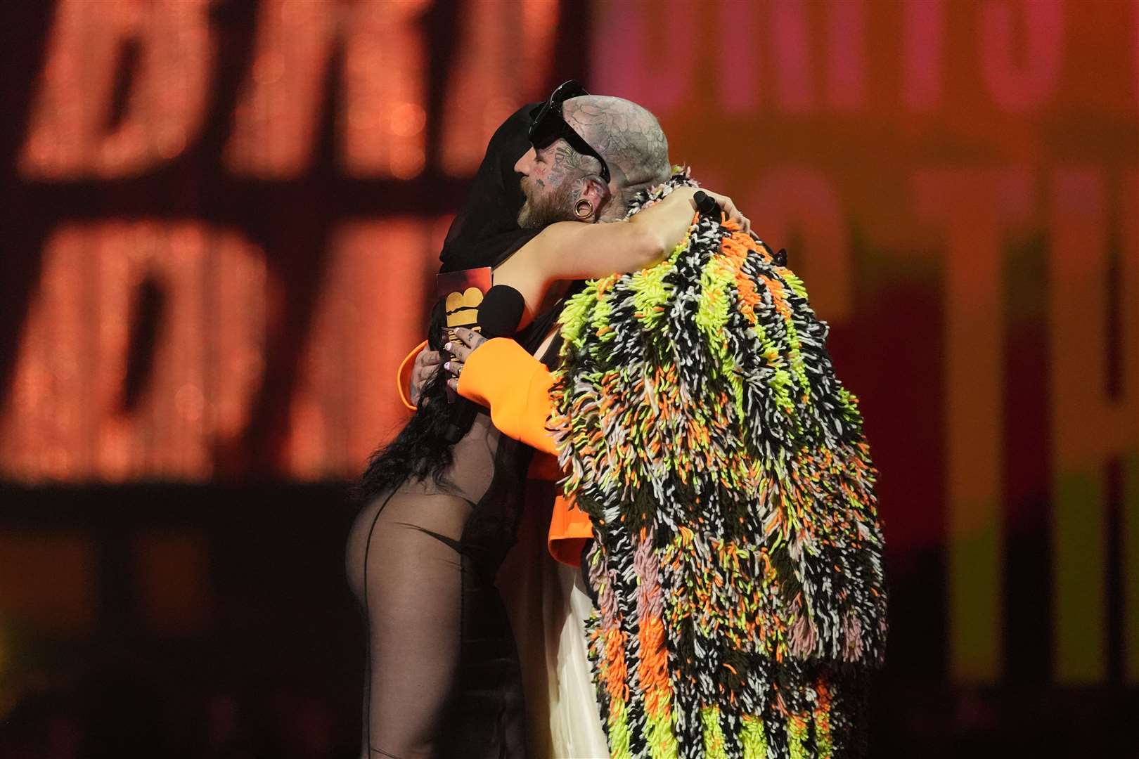 Charli XCX being congratulated by Teddy Swims, who presented her with album of the year (Lucy North/PA)