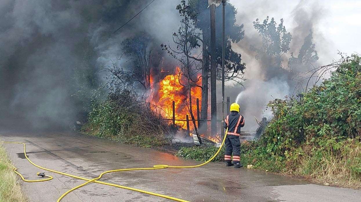 Firefighters tackle the fire in Oldfield Lane, which led to the discovery of drugs.