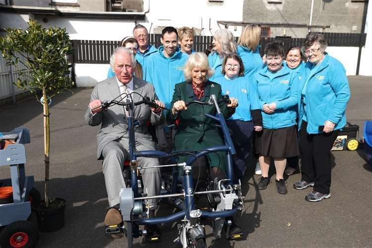 The then-Prince of Wales and the Duchess of Cornwall meet volunteers at the Superstars cafe, in Cookstown in County Tyrone (Liam McBurney/PA) (61596238)