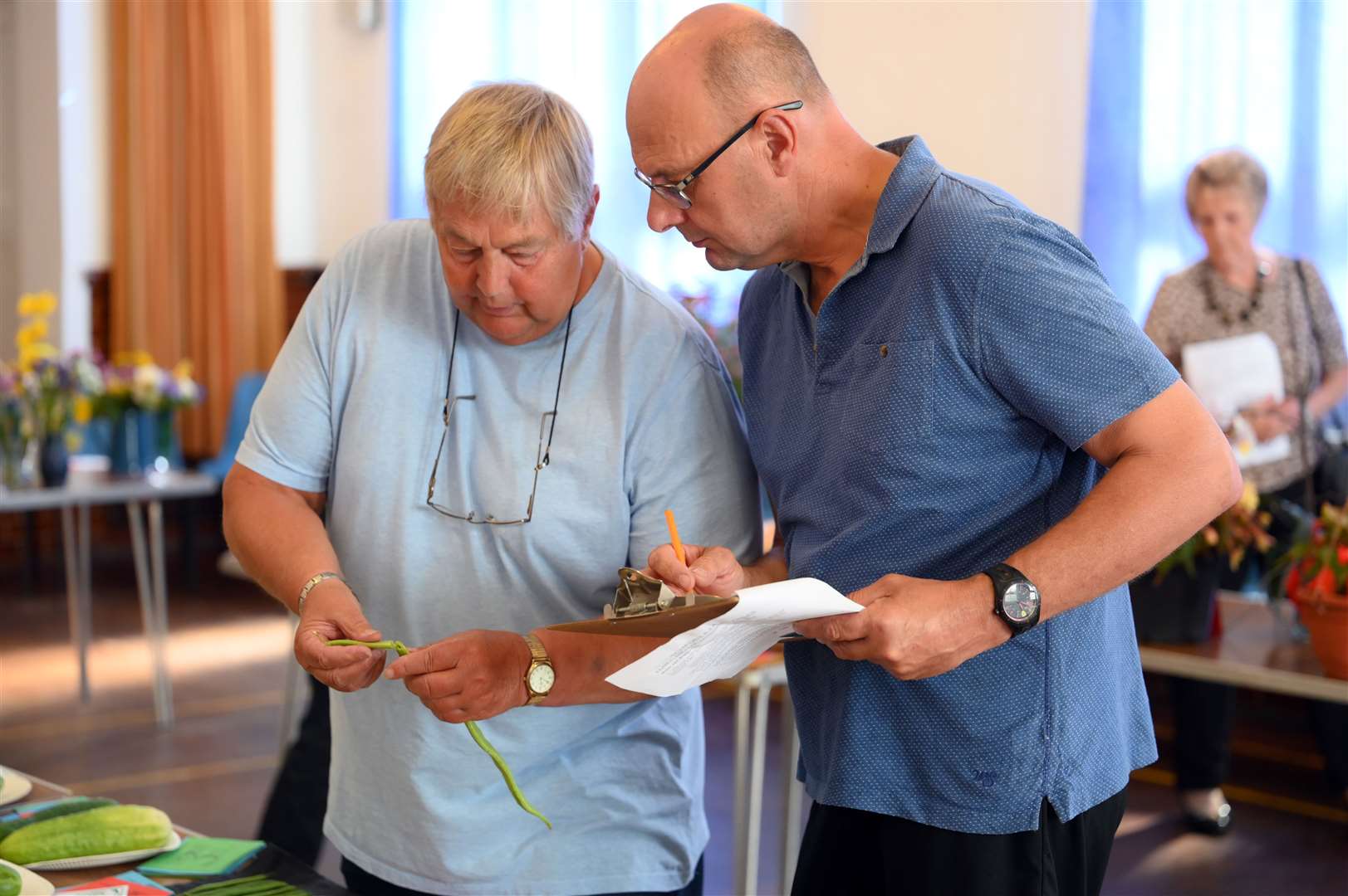 Roger Reader and David Scrimshaw check out some of the vegetable entries.