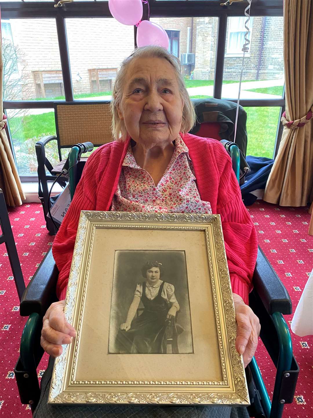 Florence Raven with a portrait of her younger self.