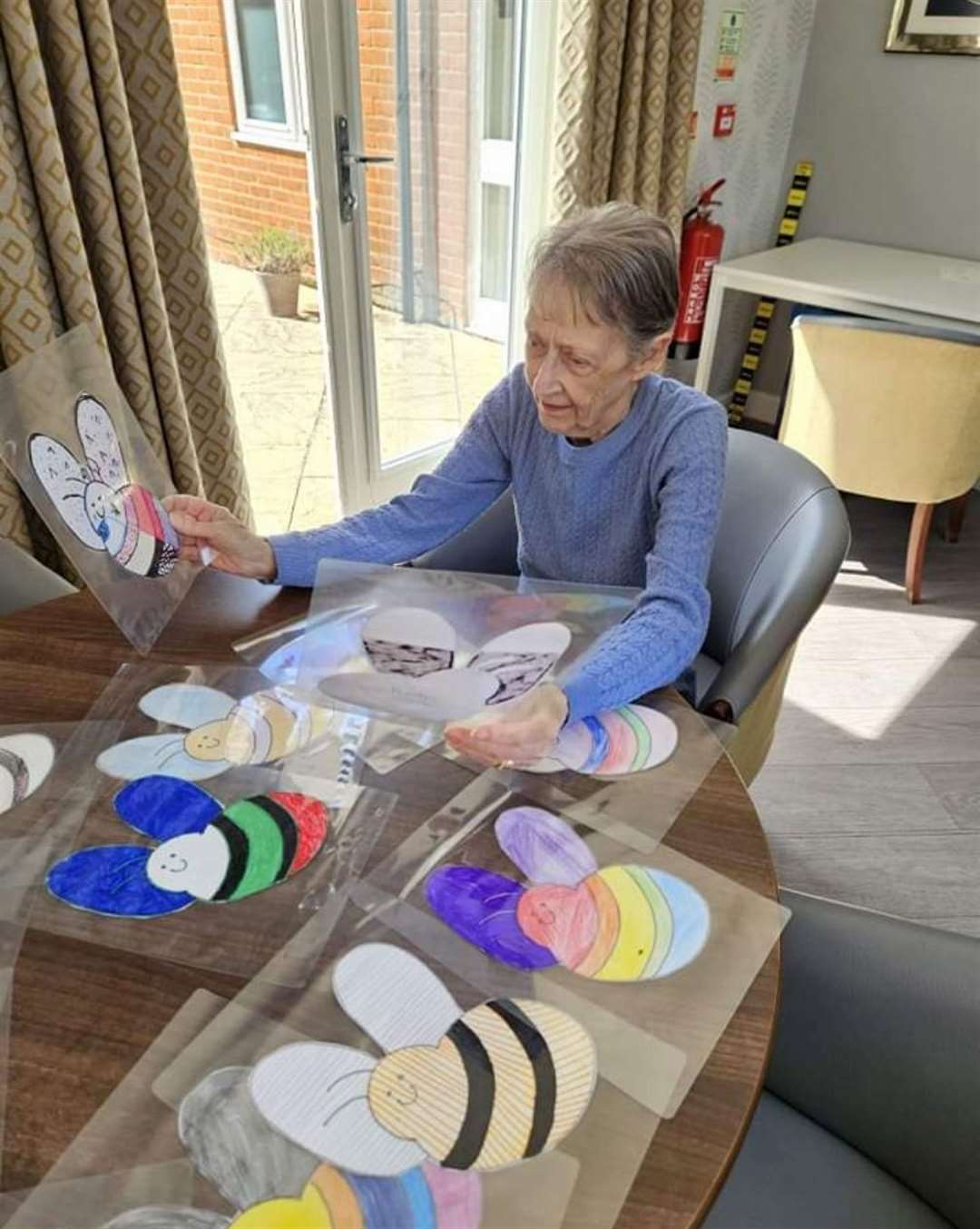 One of the Lyncroft residents sets about judging the colourful bees.