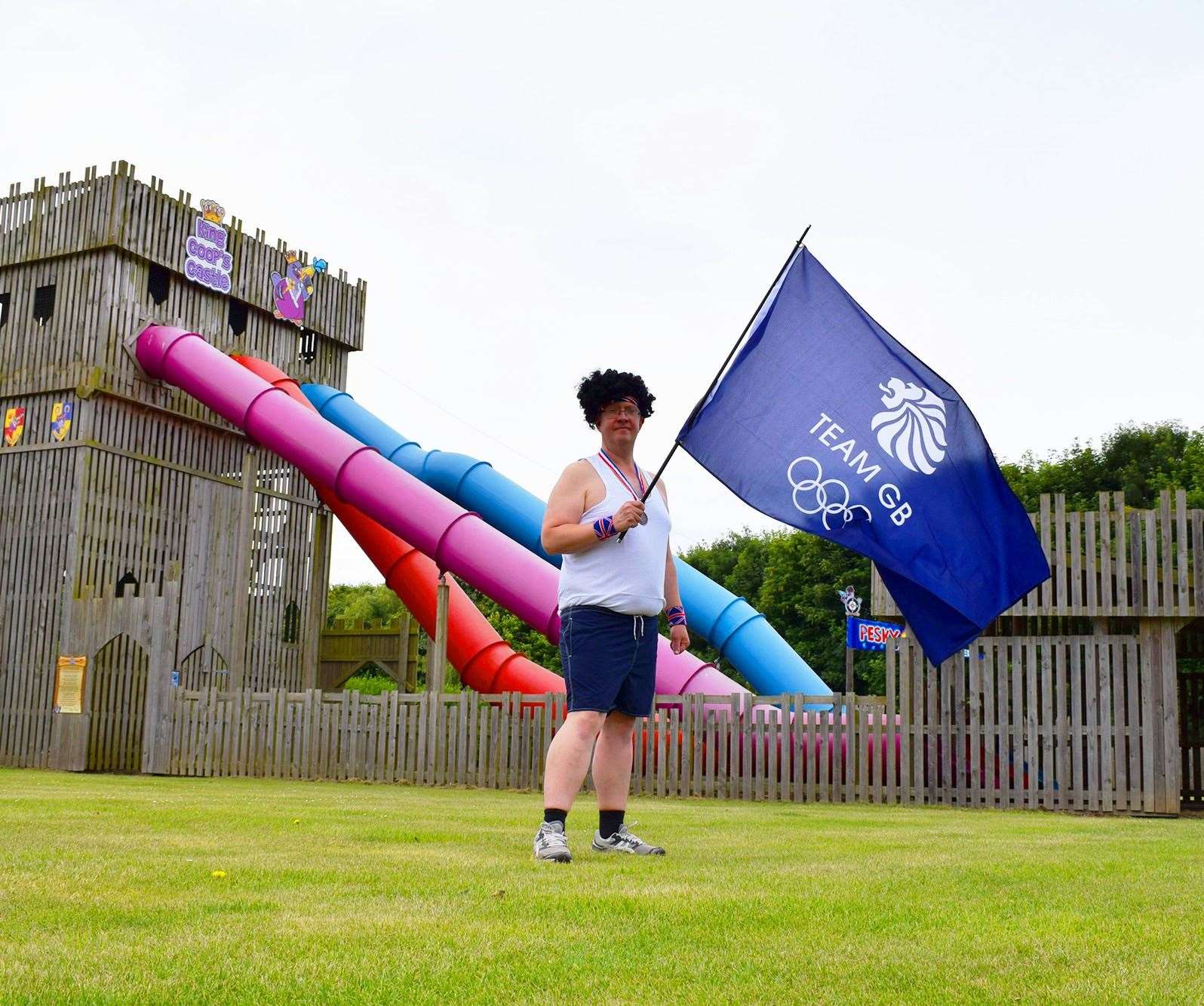 Skylark staff holding TeamGB flag in front of the slide complex.