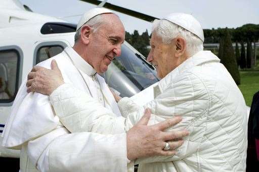 Francis, left, meets pope emeritus Benedict XVI, who served as the leader of the Catholic Church before him, in 2013 (AP)
