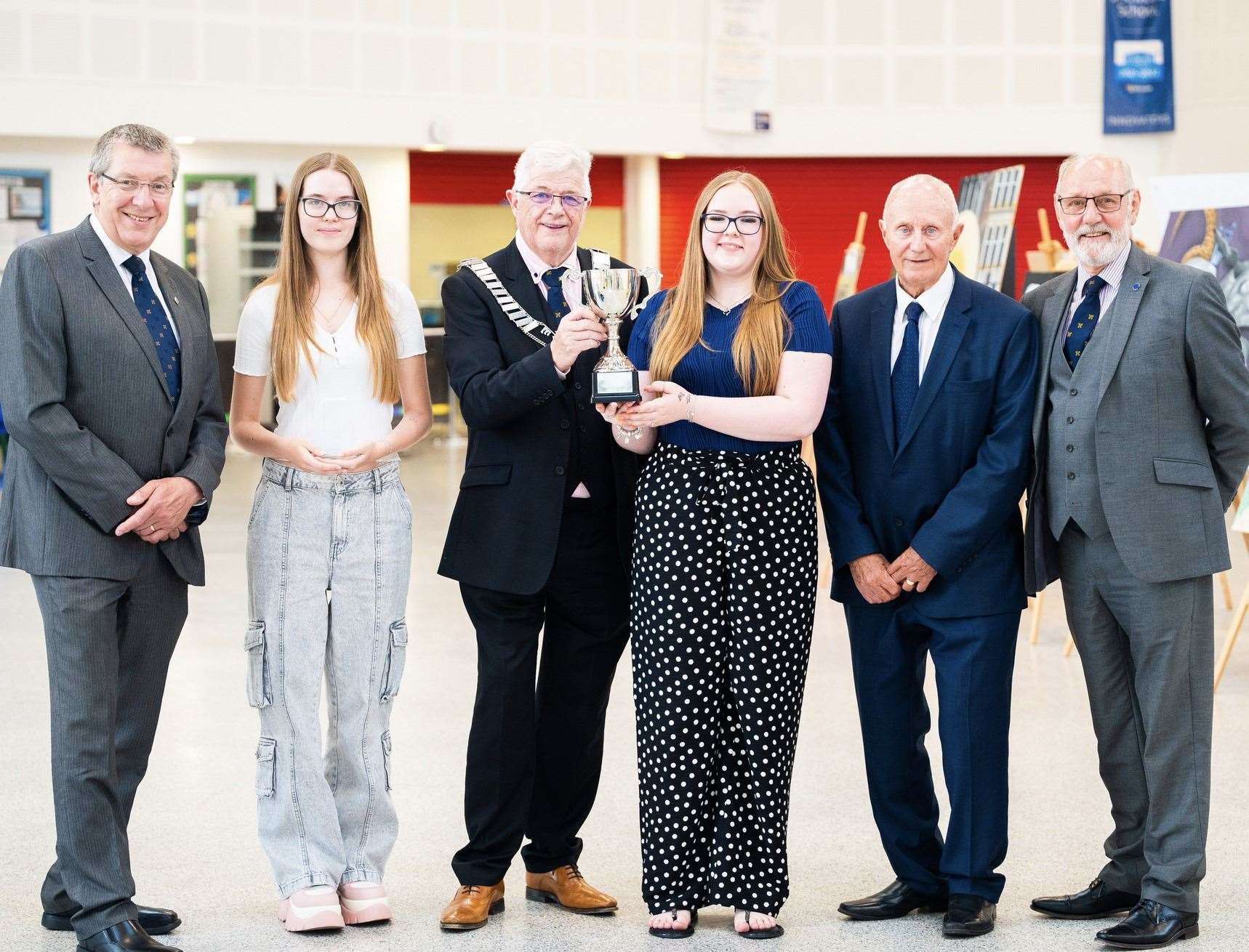 TCA business award student winners with Michael Bates, Derrick Holmes, Brian Kett, and Peter Dennis of Wisbech Business and Professional Men's Club.