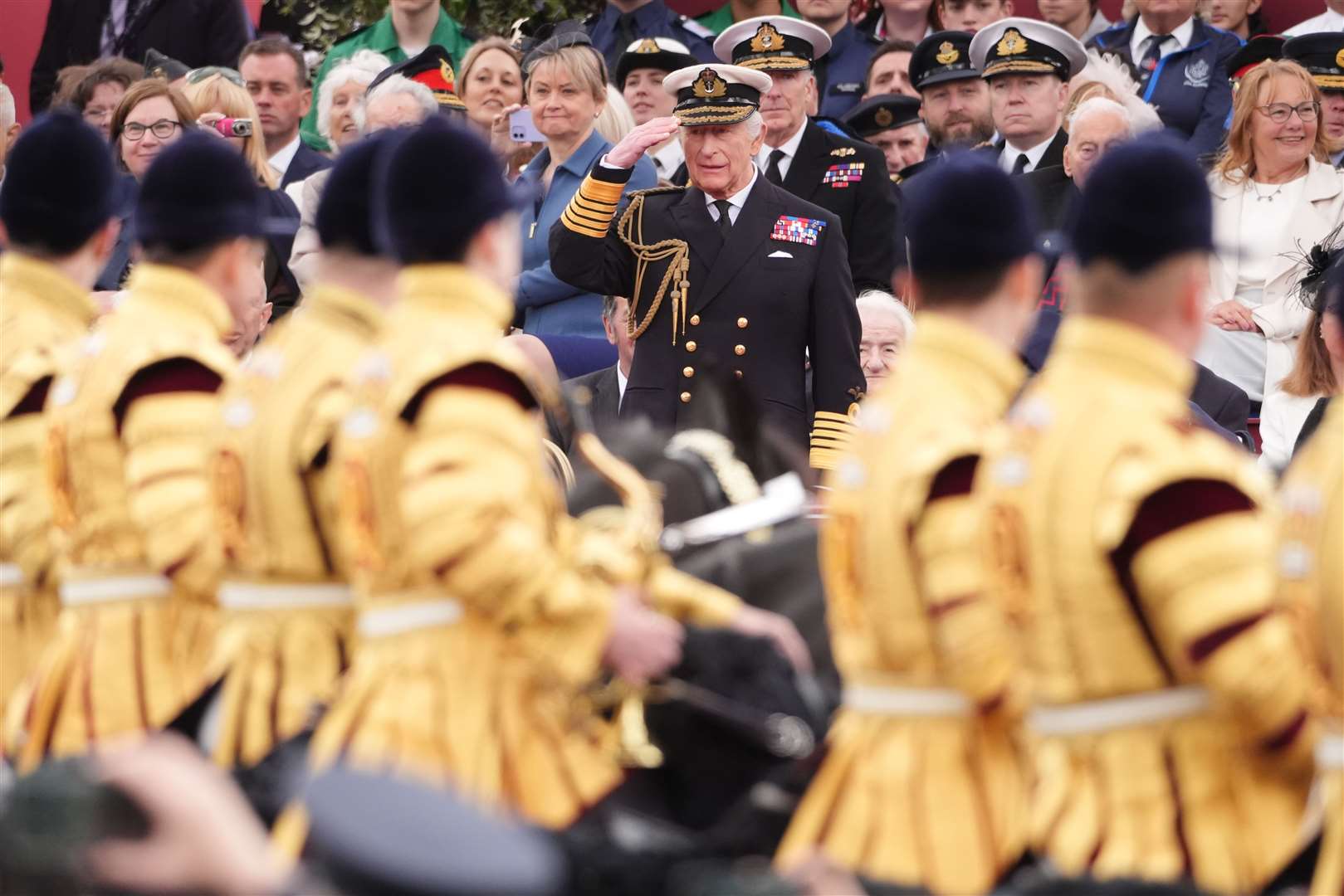 The King takes the salute from the military procession (Jonathan Brady/PA)