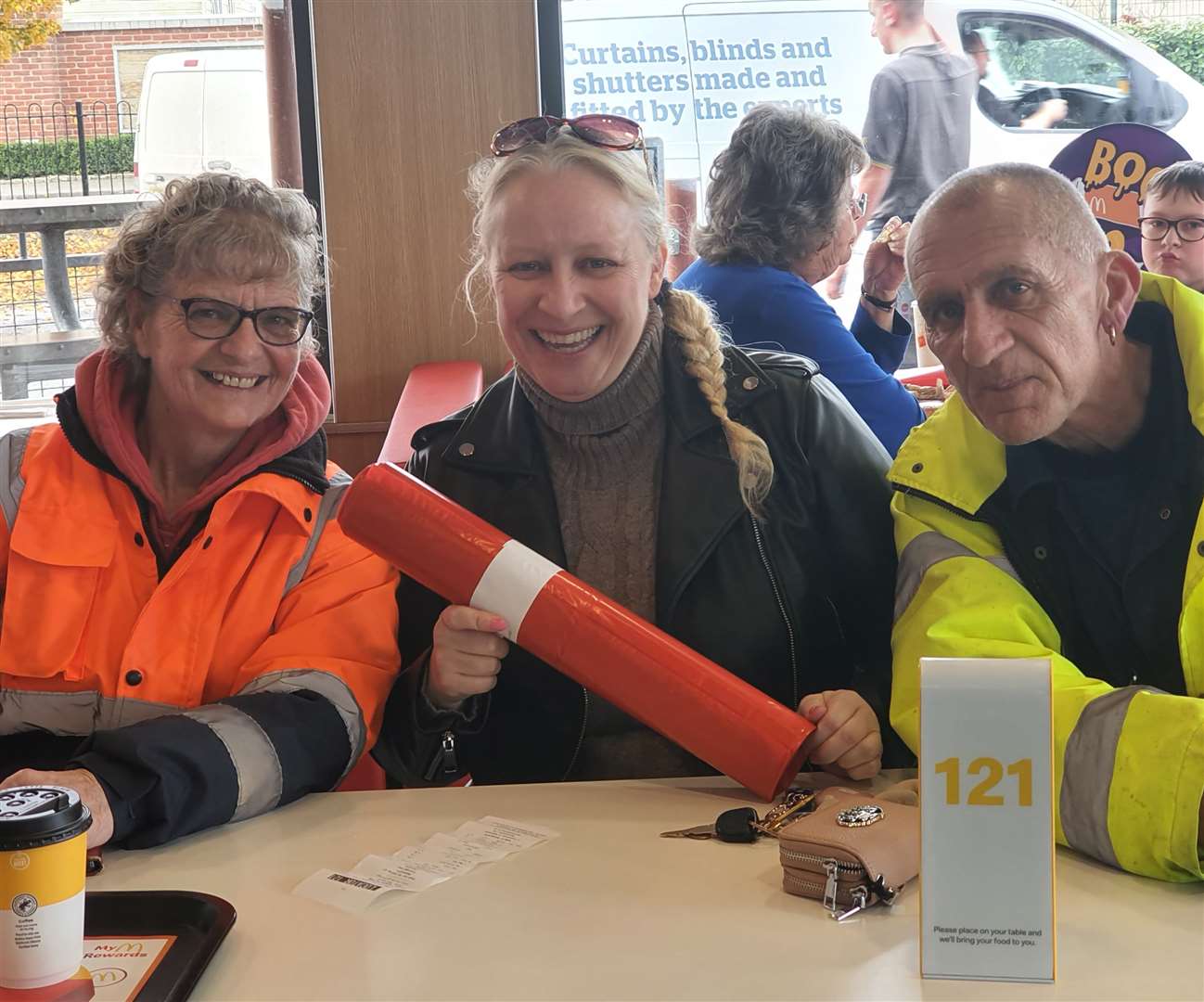 Warming up in McDonalds who donated red refuse sacks- Sutton Bridge Wombles Deanne Gough and Andy Tilley with reporter Jenny Beake. PHOTO: JENNY BEAKE