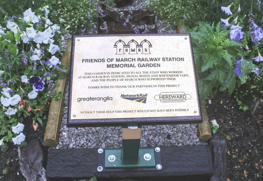 March mayor Kim French officially unveils a memorial garden at the town's railway station to remember war dead.
