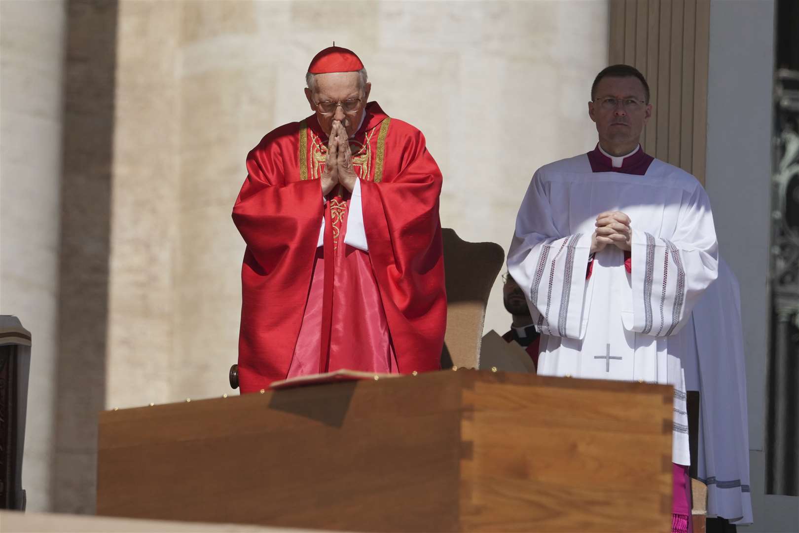 Dean of the College of Cardinals Giovanni Battista Re prays in front of the coffin (Alessandra Tarantino/AP)