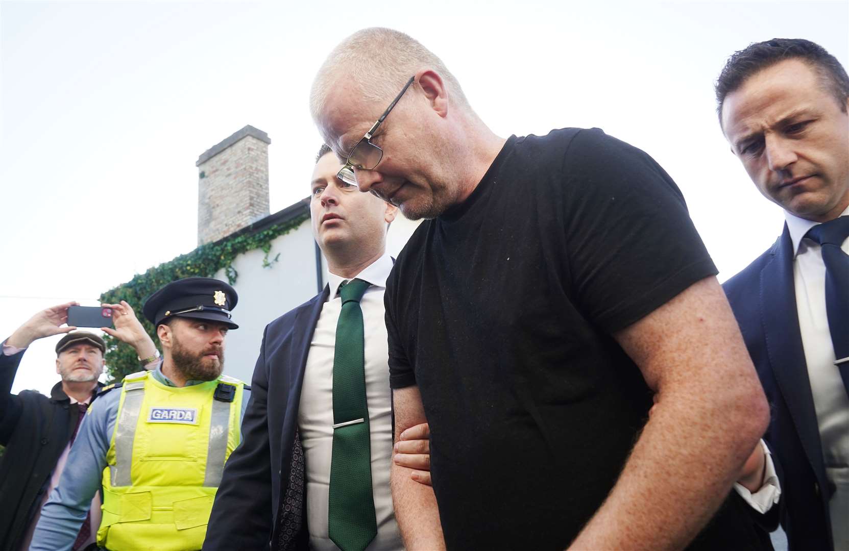 Richard Satchwell (second right) arriving at the District Court in Cashel, Co Tipperary, after being charged in connection with the murder of his wife Tina Satchwell (Brian Lawless/PA)