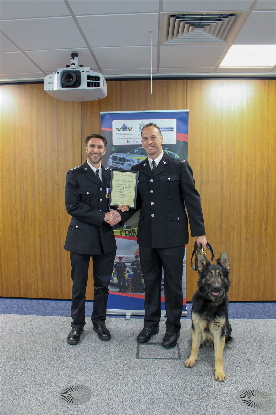 Chief Inspector Robin Sissons (left) awarding the certificate to Paul French and police dog Sonny (6158654)