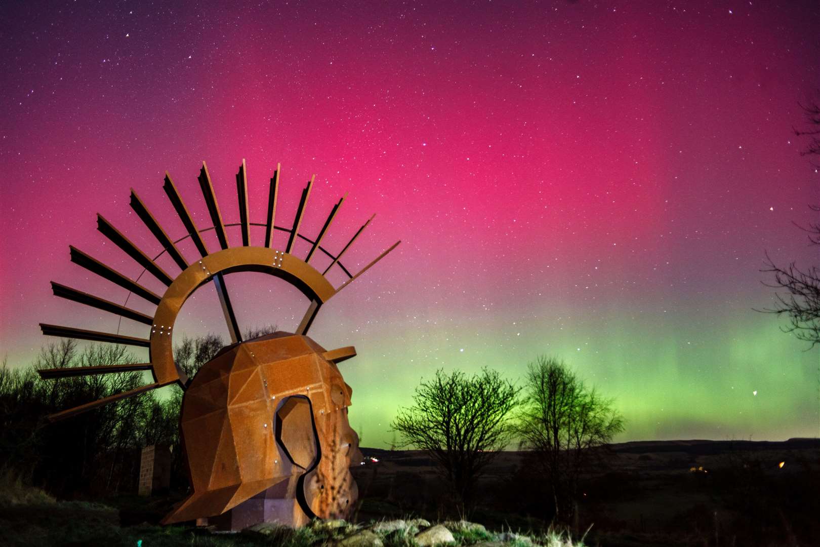 Photographer Cat Perkinton says: "Absolutely nuts aurora Sunday evening, with the lights making a show from 8pm right through the night. This taken at the 6 metre tall Silvanus Roman sculpture on Croy Hill, North Lanarkshire around 10pm, with reds & greens visible to the eye." (62664061)