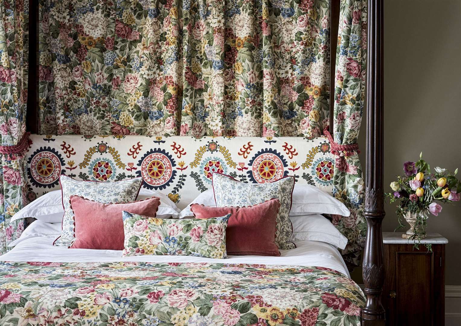Drapes and bedspreads showing the Hydrangea Rose pattern with a headboard of the Annabel’s Suzani fabric (Highgrove by Sanderson/Sanderson Group/PA)