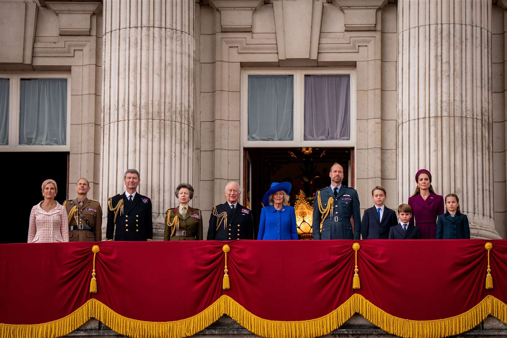 Members of the royal family observe the national anthem after watching the VE Day RAF flypast (Aaron Chown/PA)