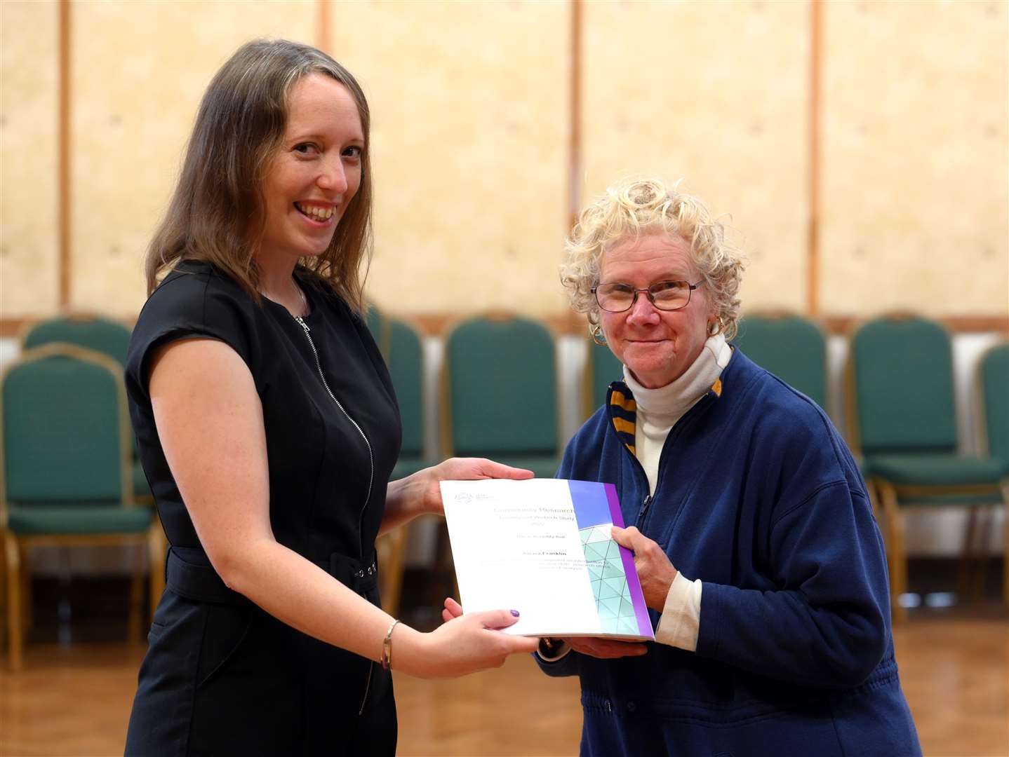 Alexia Franklin receives her certificate from Susan Coan (left).