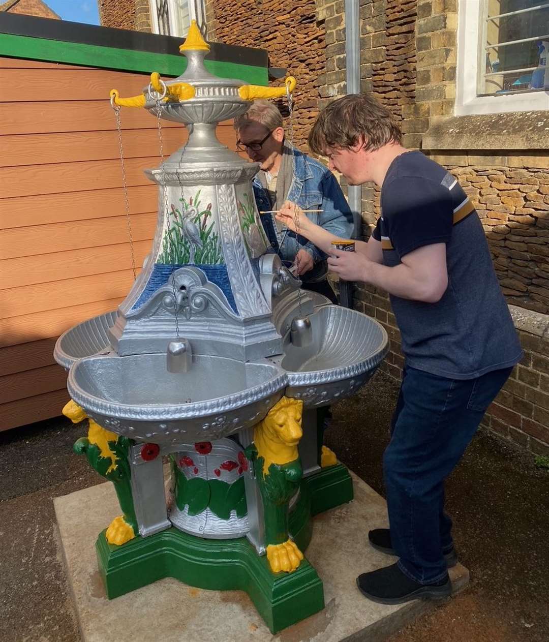 Kelvin Adams and Alex King (right) put some finishing touches to the paintwork