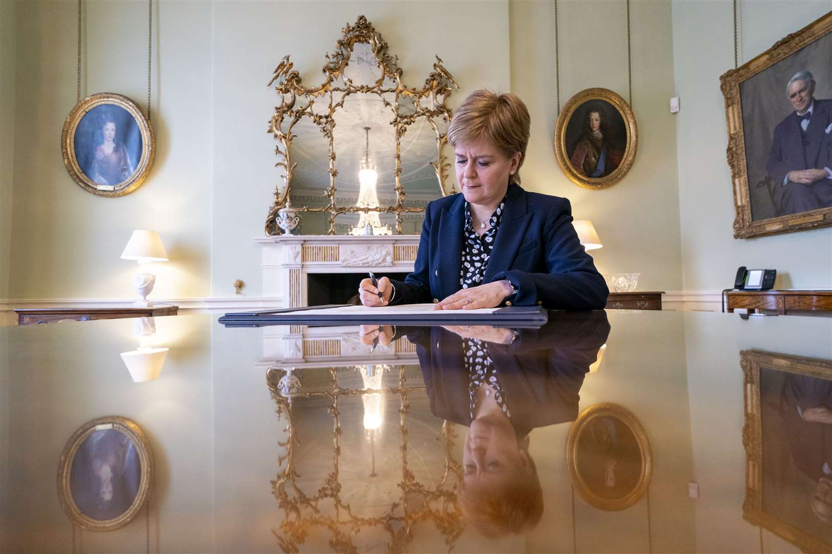 Outgoing First Minster of Scotland Nicola Sturgeon signs her official resignation letter to the King (Jane Barlow/PA)