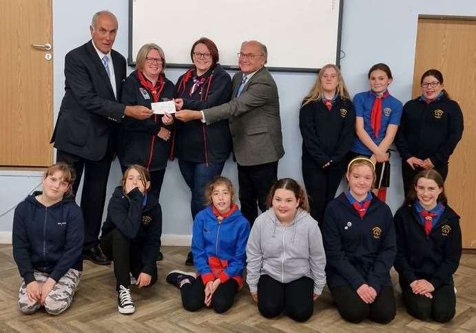 From left: Guide Leaders Marcia Whitehead and Natalie Taylor receiving a cheque from Wisbech Freemasons David Broker and Richard Smith, pictured with some of the Guides.