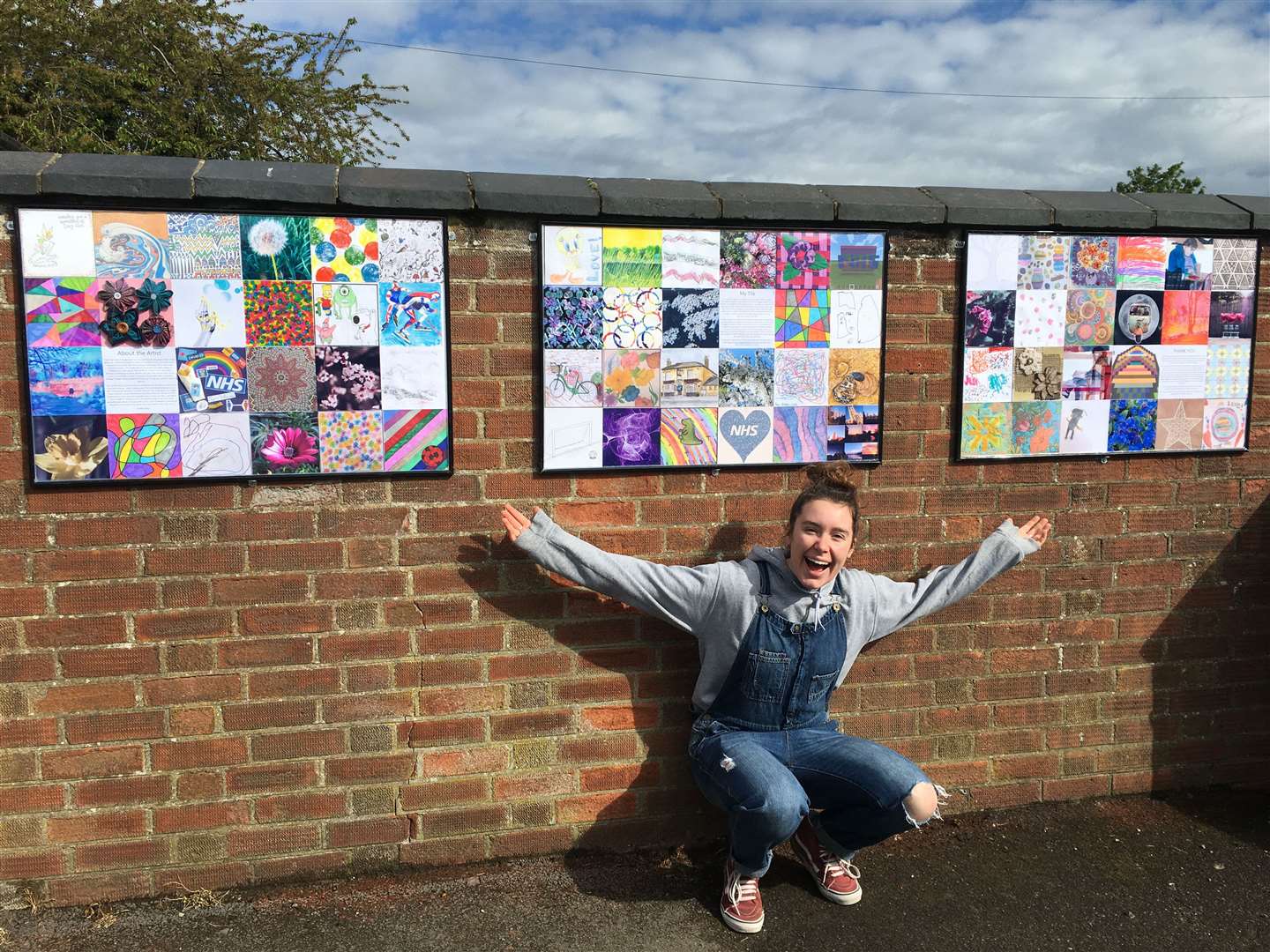Maggie Powell with the tiles that are now on display outside the village pub.