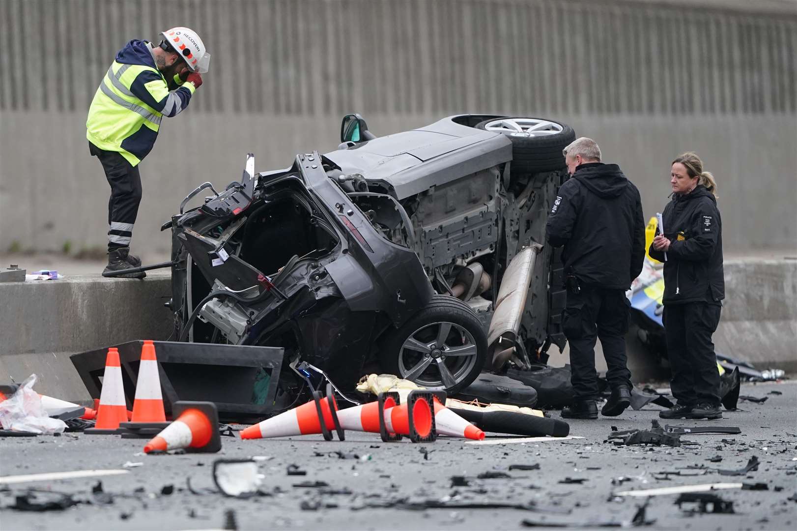 Police examine one of the vehicles after the collision (Owen Humphreys/PA)