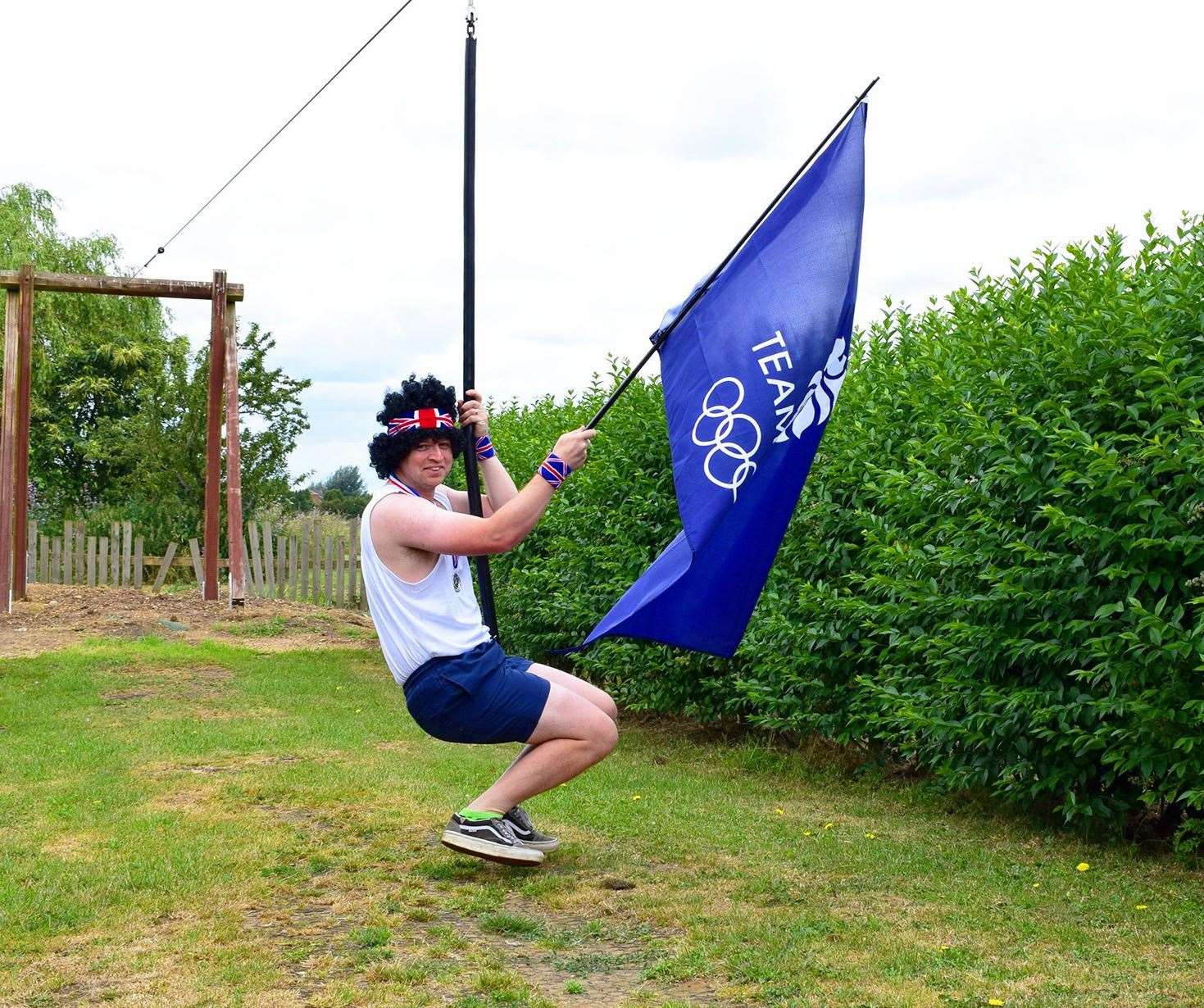 Skylark staff Riding Zip-Wire with TeamGB flag.