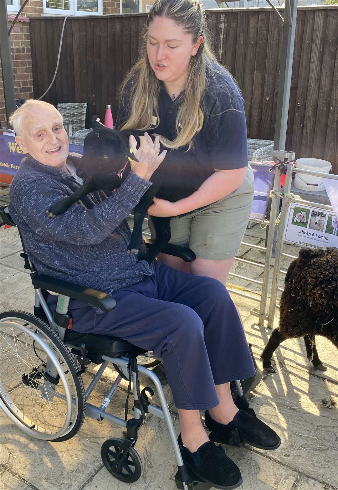 A resident happy to meet a black Lab