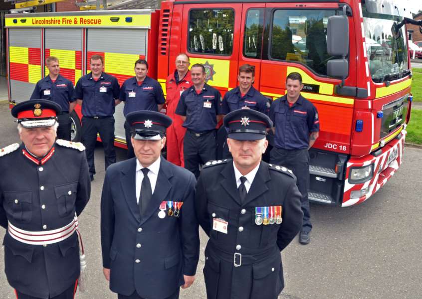 Richard King BEM (centre), watch manager at Long Sutton Fire Station, with firefighters, Lord Lieutenant of Lincolnshire Toby Dennis and Deputy Divisional Manager for Lincolnshire Fire and Rescue, Pete Wiles. Photo by Tim Wilson.