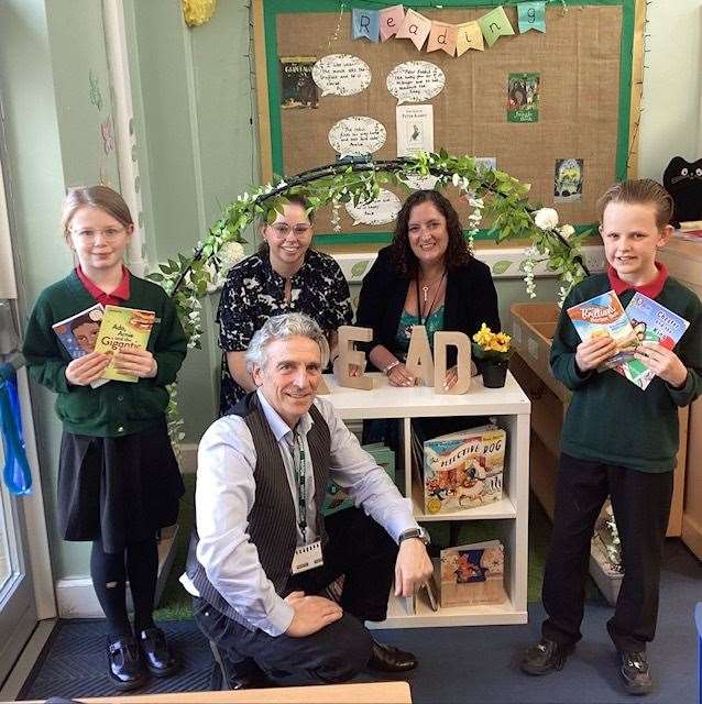 Author Richard O'Neill (front) with pupils, literacy lead Katie Crawley and head teacher Sarah Cullen