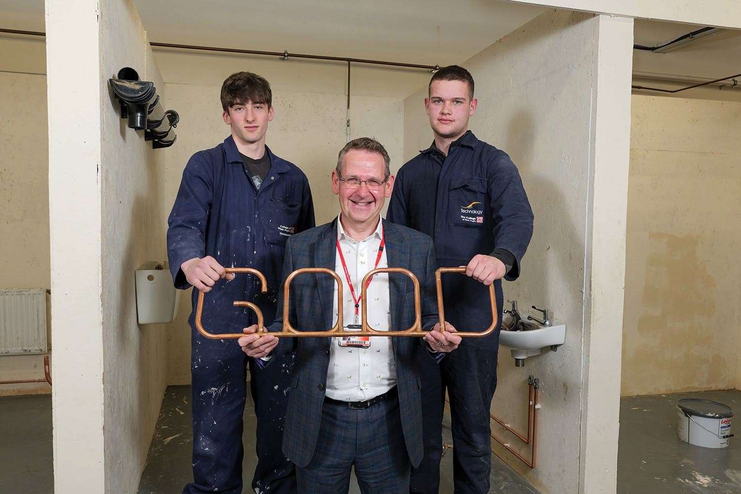 Principal David Pomfret with Plumbing students Harvey Feller and Jack Arnold, who made the copper 'Good' sign. Picture: College of West Anglia