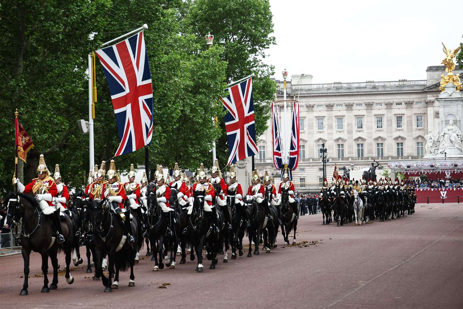 Members of the Household Cavalry, Life Guards front, followed by the Blues and Royals ride along The Mall (Henry Nicholls/PA)